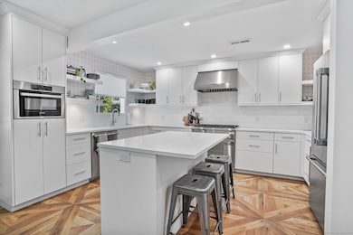 Remodeled kitchen with Custom cabinets, thermador gas range, refrigerator and dishwasher.