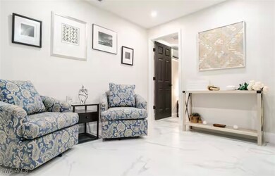 Living area with recessed lighting and marble fini