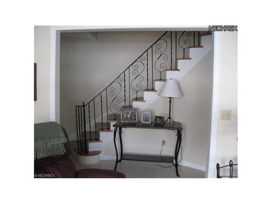 View of foyer and staircase from living room.