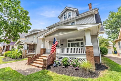 View of front of home with a garage and a porch