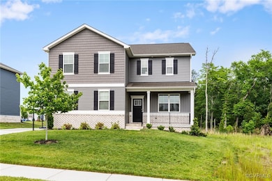 View of front facade with a porch, a front yard, r
