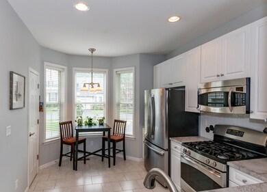 Another look at your eat in kitchen with tons of natural light pouring in through your 3 large windows, and recessed lighting for when you need them....Pantry door on left