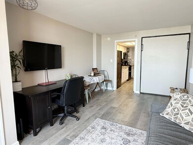 Office space with light wood-style flooring and baseboards