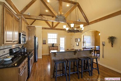 Vaulted ceiling and rustic beams continue in the b