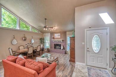 Living room with a textured ceiling, brick wall, a