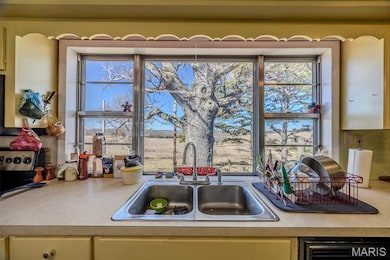 Kitchen with a sink and light countertops