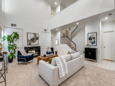 Carpeted living room with a towering ceiling, wet 