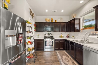The cute kitchen features a pantry and a window overlooking the backyard.





