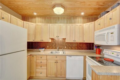 The kitchen features full-sized appliances, shaker