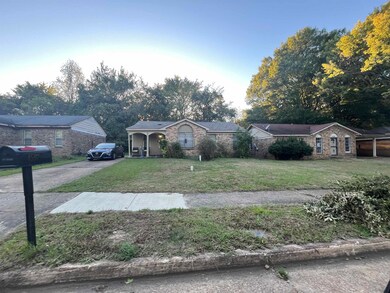 Single story home featuring a front lawn