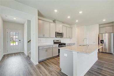 Kitchen featuring stainless steel appliances, a si