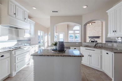 Kitchen featuring visible vents, a kitchen island,