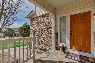 View of exterior entry featuring stone siding and 
