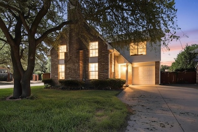 Traditional home with brick siding, driveway, and a garage