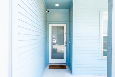 Doorway to property featuring a surveillance syst