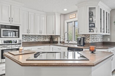 Kitchen featuring a sink, dark countertops, applia