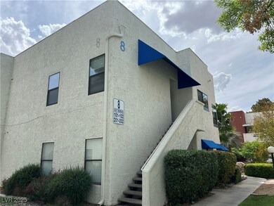 View of property exterior with stairway and stucco