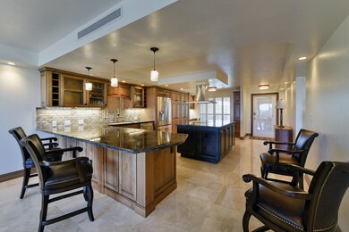 Marble floors open kitchen to bar area