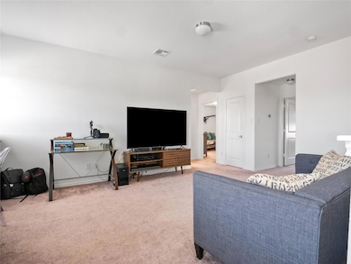 Living area featuring light carpet