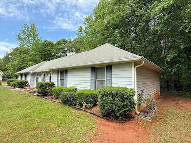 View of side of home with a yard