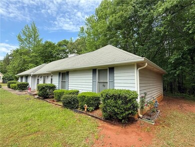 View of side of home with a yard
