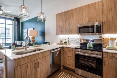 Kitchen with pendant lighting, sink, appliances wi
