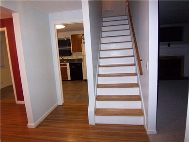 Foyer. Hardwood floors. Behind is tile vestibule w