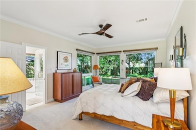 Primary bedroom with views of the lush backyard