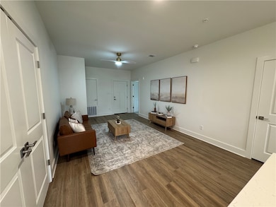 Living room featuring ceiling fan, visible vents,
