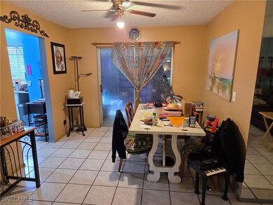Dining space with ceiling fan, a textured ceiling,