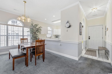 Dining room featuring light colored carpet, visibl
