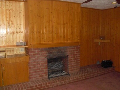 The large living room is warmed by the knotty pine