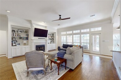 Living room with visible vents, built in shelves,