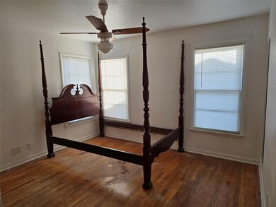 Bedroom with dark hardwood / wood-style floors and