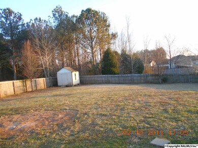 Large back yard with privacy fencing and storage building