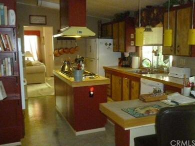 View of kitchen and breaksfast bar from den