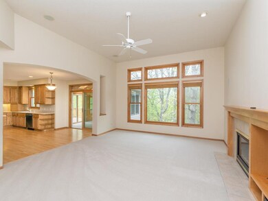 Family Room has new carpeting, a high ceiling, gas