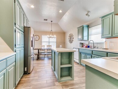 Kitchen with stainless steel refrigerator with ice