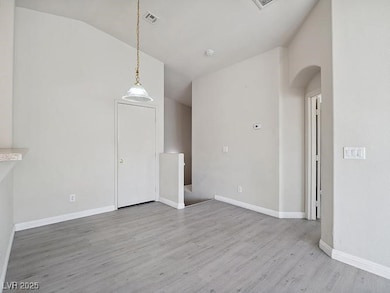 Unfurnished living room featuring lofted ceiling,