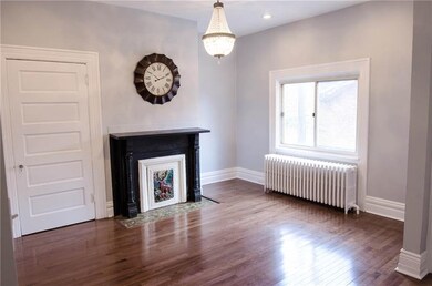 Beautiful livingroom with hardwoods and original f