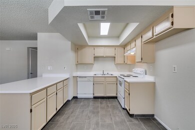 Kitchen featuring white appliances, a peninsula, u