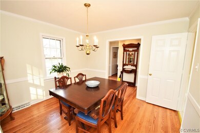 The Formal Dining Room Features Crown Moulding and