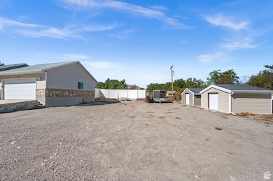 View of property exterior featuring an outdoor structure, a garage, and brick siding