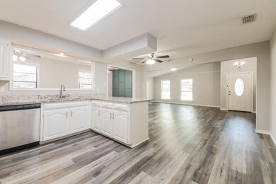 Kitchen featuring stainless steel dishwasher, whit