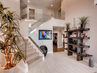 Tile entry with a glass walled staircase