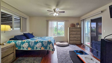 Bright, breezy bedroom with views of lush greenery—so much space, plus private lana‘i access for your morning coffee or pau hana relax time.