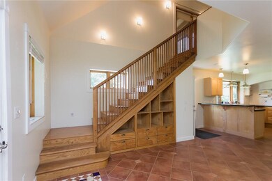 The custom stair way features built-ins and hidden storage.