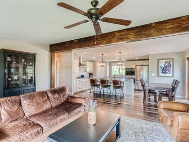 An entertainers dream kitchen with beverage fridge, gas cooktop, double oven, farmers sink and a HUGE 7' x 6' island