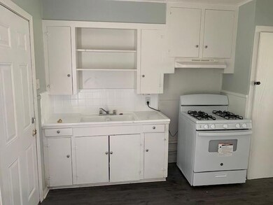 Kitchen with gas range gas stove, dark hardwood / 