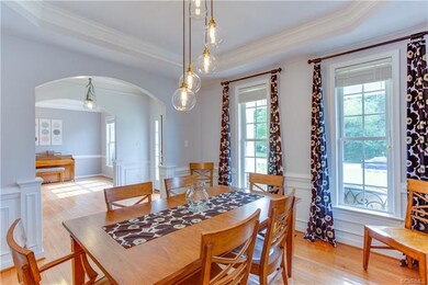 Formal dining room.  Tray ceiling...upgraded artistic chandelier...beautiful moldings and wood work.